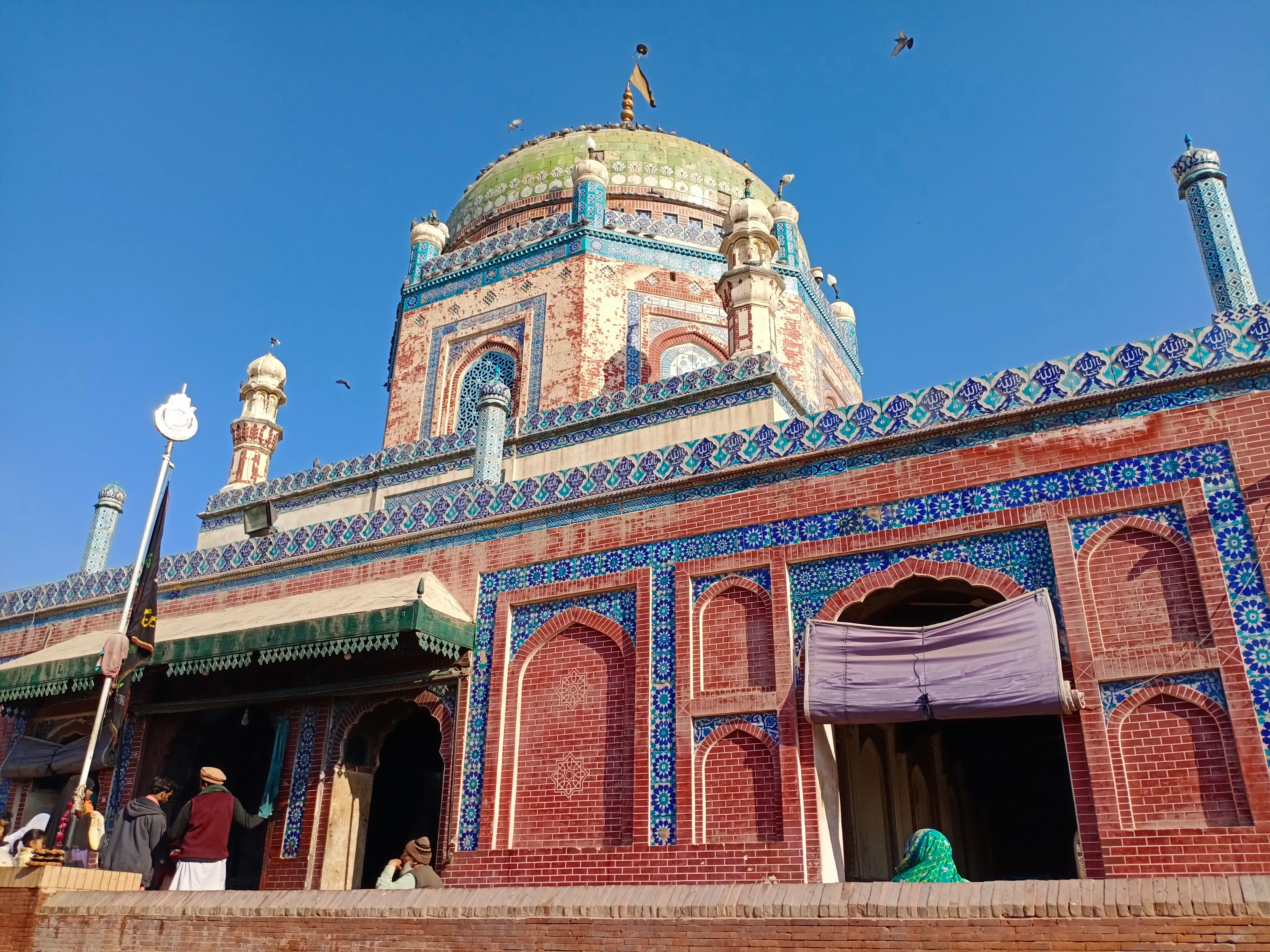 The dome of Shah Rukn-e-Alam shrine with blue and turquoise Multani tilework rising above Multan Fort